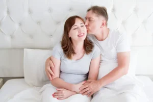 middle-age-family-couple-white-bedroom-bed-husband-kiss-wife-love-romance-healthy-relationship-middle-age-family-couple-128238644-300x200-1.webp